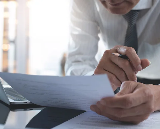 businessman reading carefully terms, conditions of business contract at office, close-up