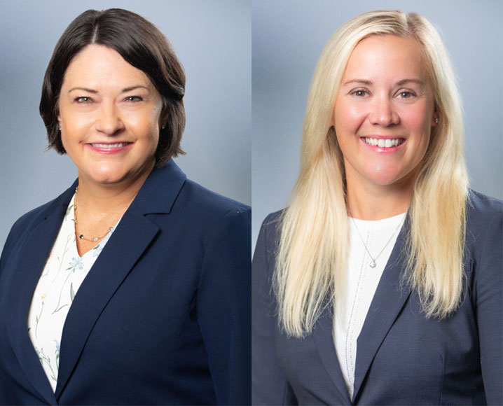 Two women smile at camera
