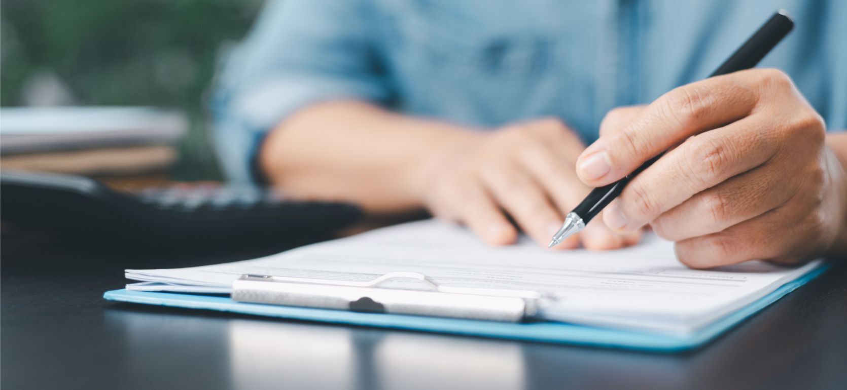 Someone signing a document.