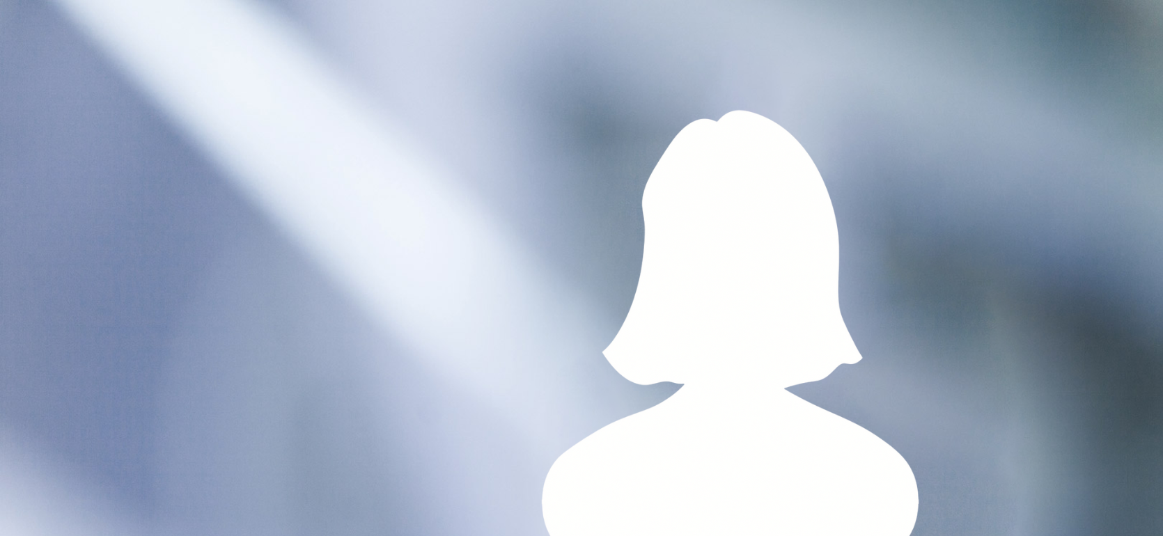 Silhouette of a woman with shoulder-length hair on a soft, blue and white blurred background