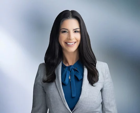 A picture of Courtney Agrusa smiling at the camera.