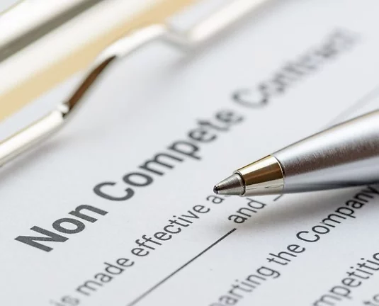 Picture of a non-compete agreement document with a pen.