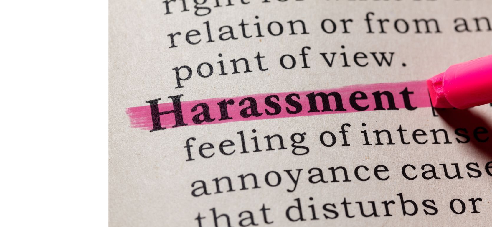 A definition of harassment highlighted in pink.