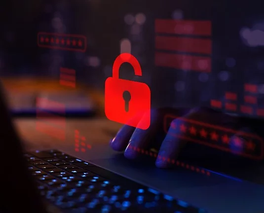 A digital red lock floating in the air in front of a person on their laptop.