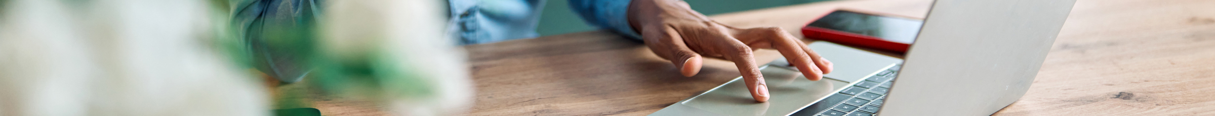 Hand scrolls over laptop mouse pad