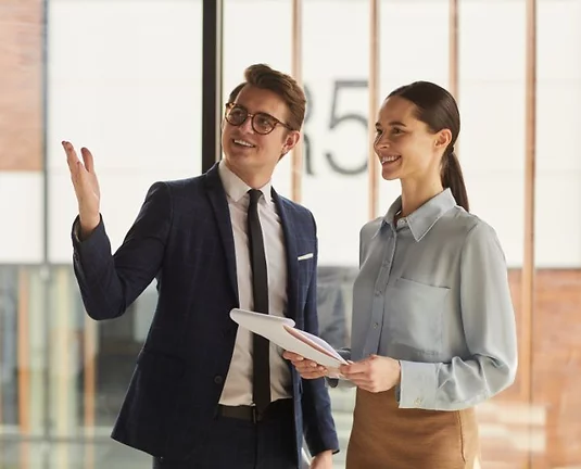 Two people talking in a building,