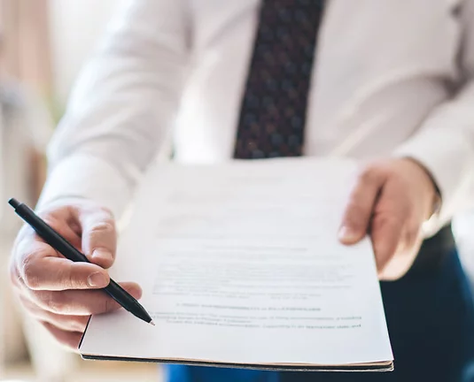 Faceless male employee giving document to sign