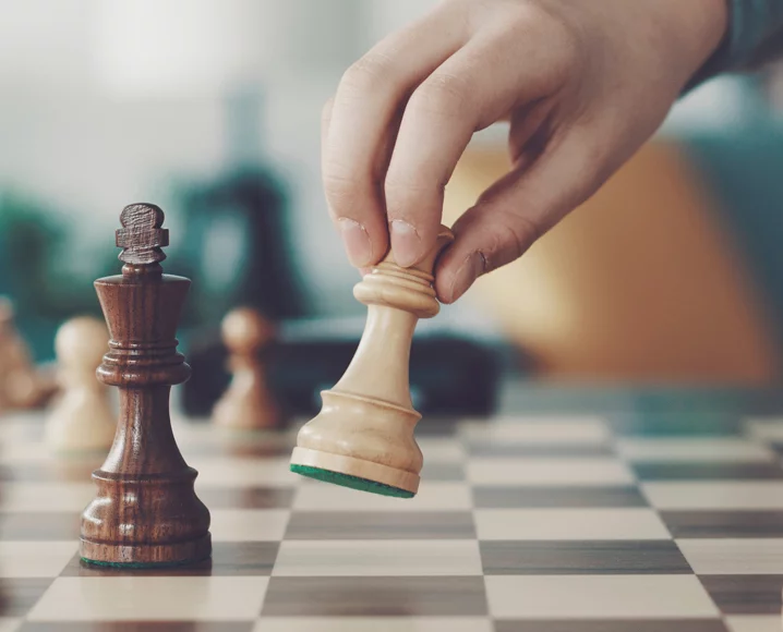 Single hand moving a chess piece