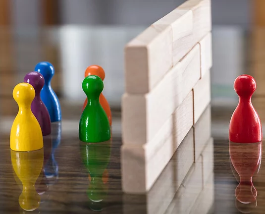 Red Green Purple Yellow Orange And Blue Figurines Paw Separated By Wooden Blocks