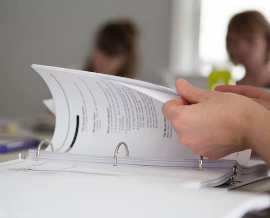 Someone flipping through document pages.