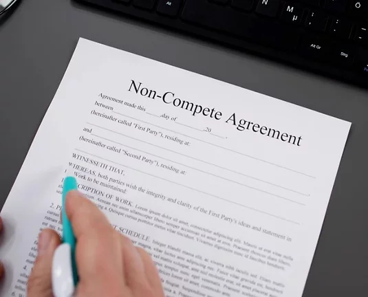 Person reading a non-compete agreement contract.