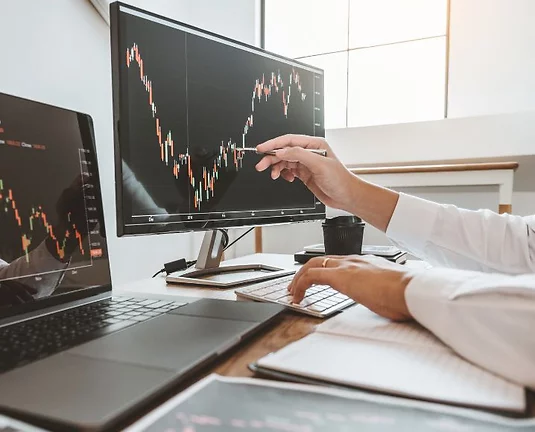 A man reading stocks on a computer.