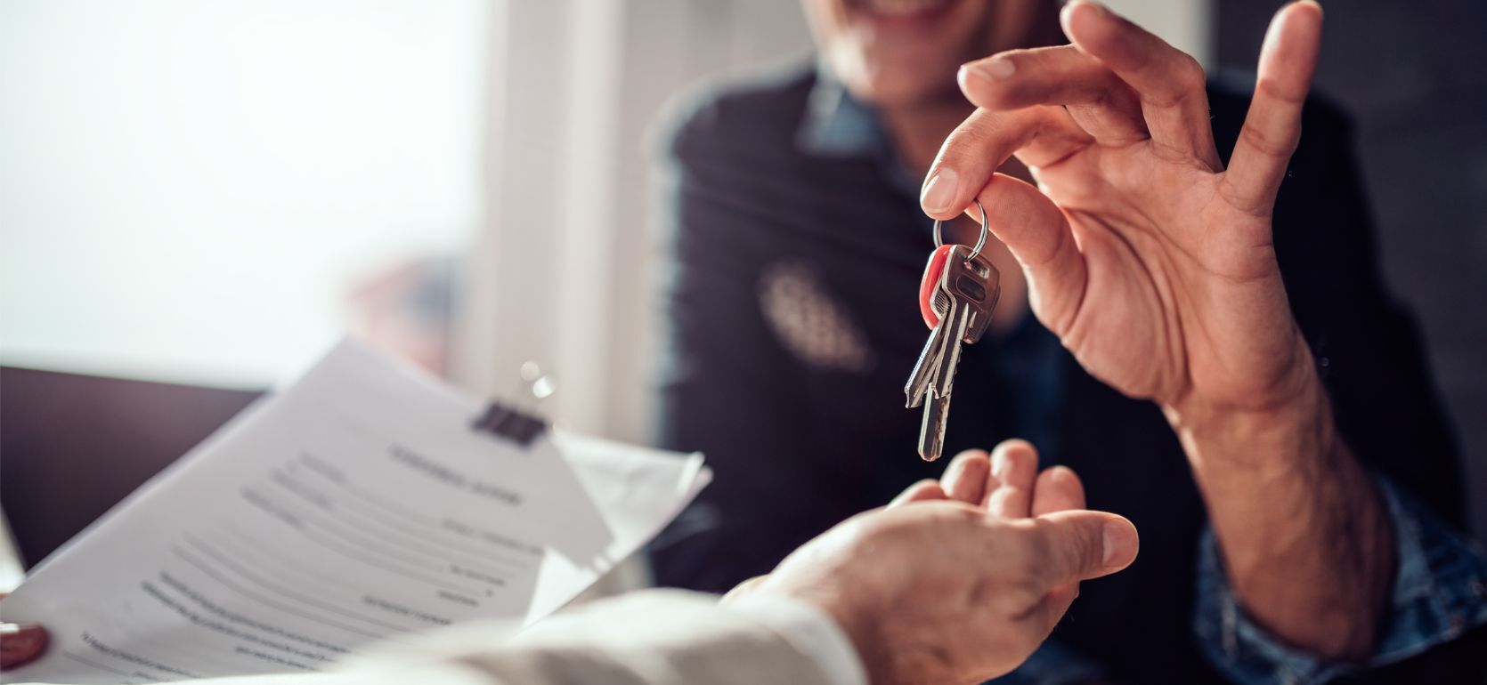Someone handing off house keys.