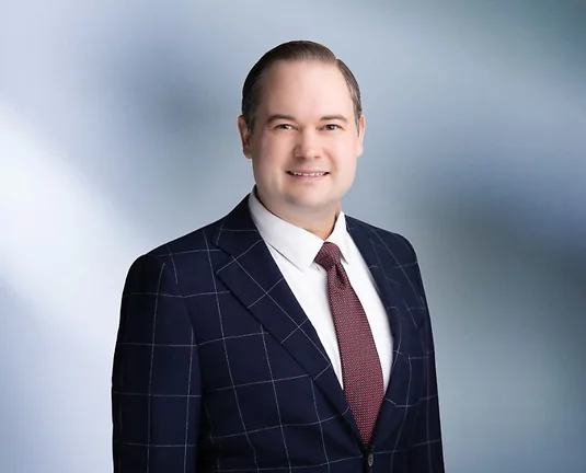 Picture of Alex Rusek smiling at the camera.