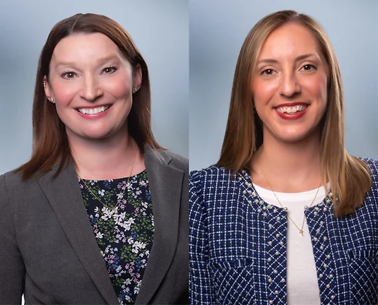 Two women attorneys, Laura Kane on left and Allison Morris on right, smile at camera