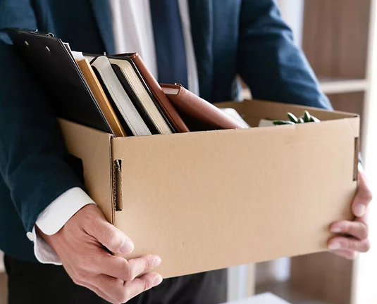 Sad Fired Young Employee businessmen hold boxes including pot plant and documents for personal belongings unemployment, resigned concept.