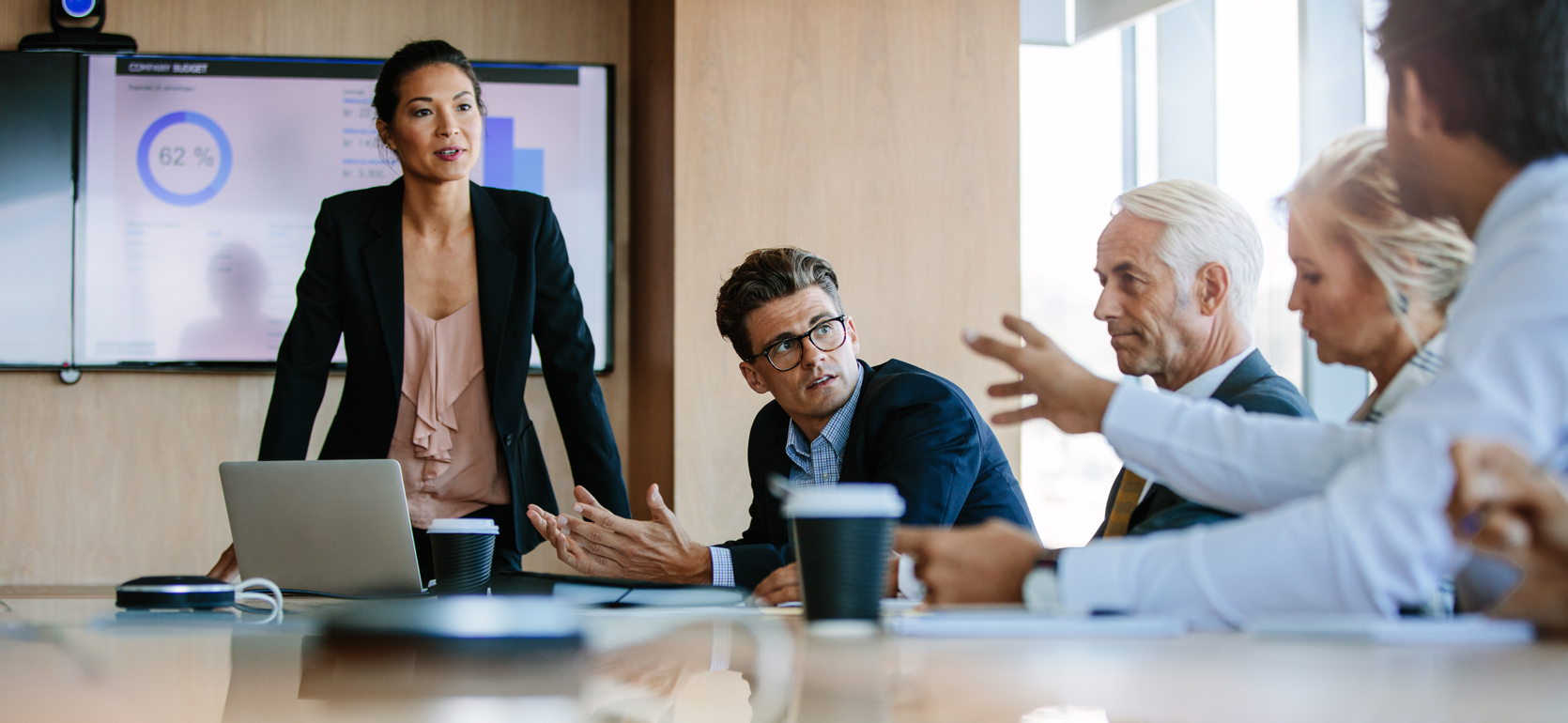 People of various ages talking in a boardroom