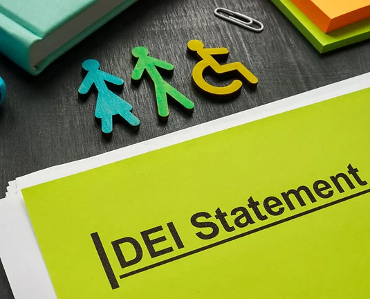 DEI statement documents and small colorful figurines.