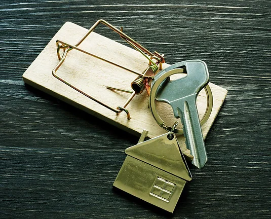 Mousetrap and house keys. Mortgage fraud Home buying scam.