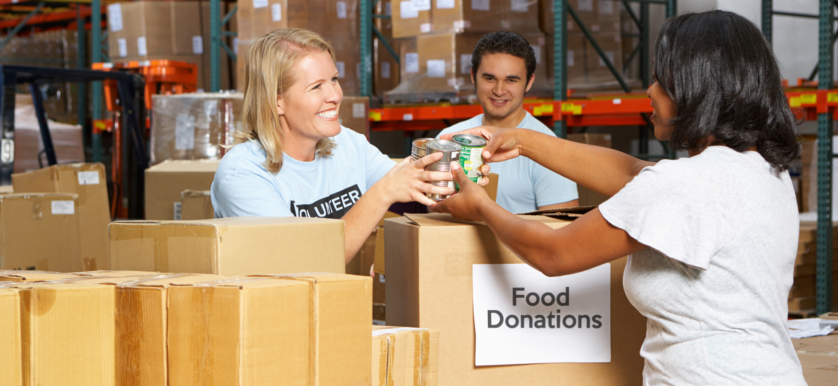 Volunteers accepting food donations surrounded by boxes