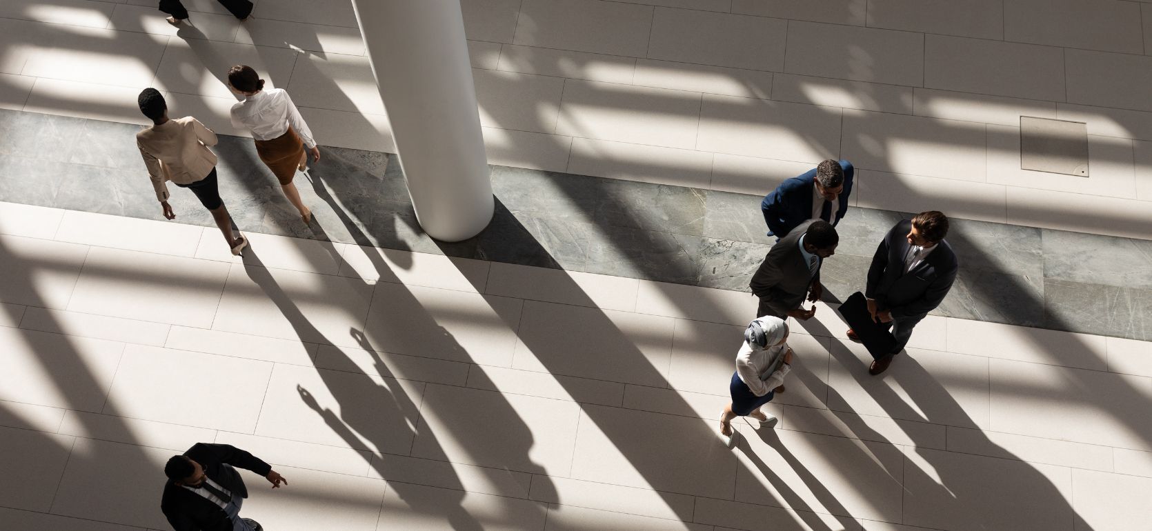Birds eye view of people walking around a government building.