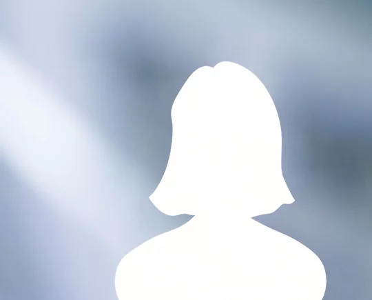Silhouette of a woman with shoulder-length hair on a soft, blue and white blurred background