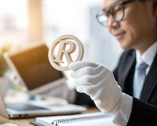 Registered Trademark Symbol Held by Business Professional