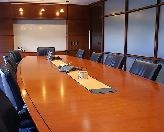 Meeting room with chairs and a white board.