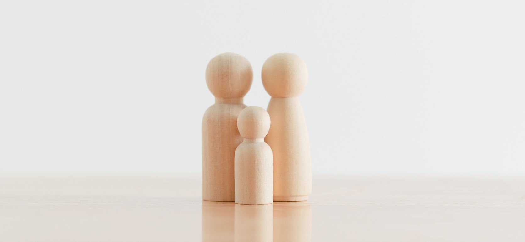 Three wood figures on a white background.